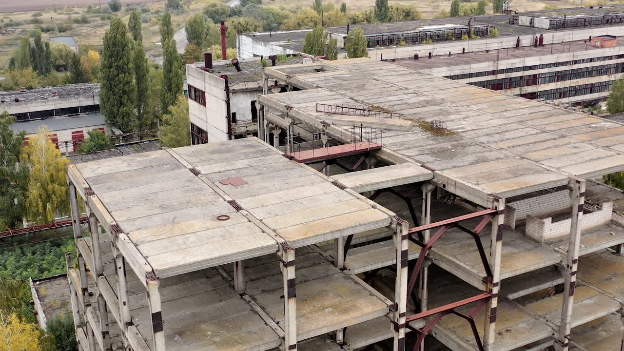 Ruined buildings. Industrial constructions without windows on abandoned plant. Old manufacture. Circling view.