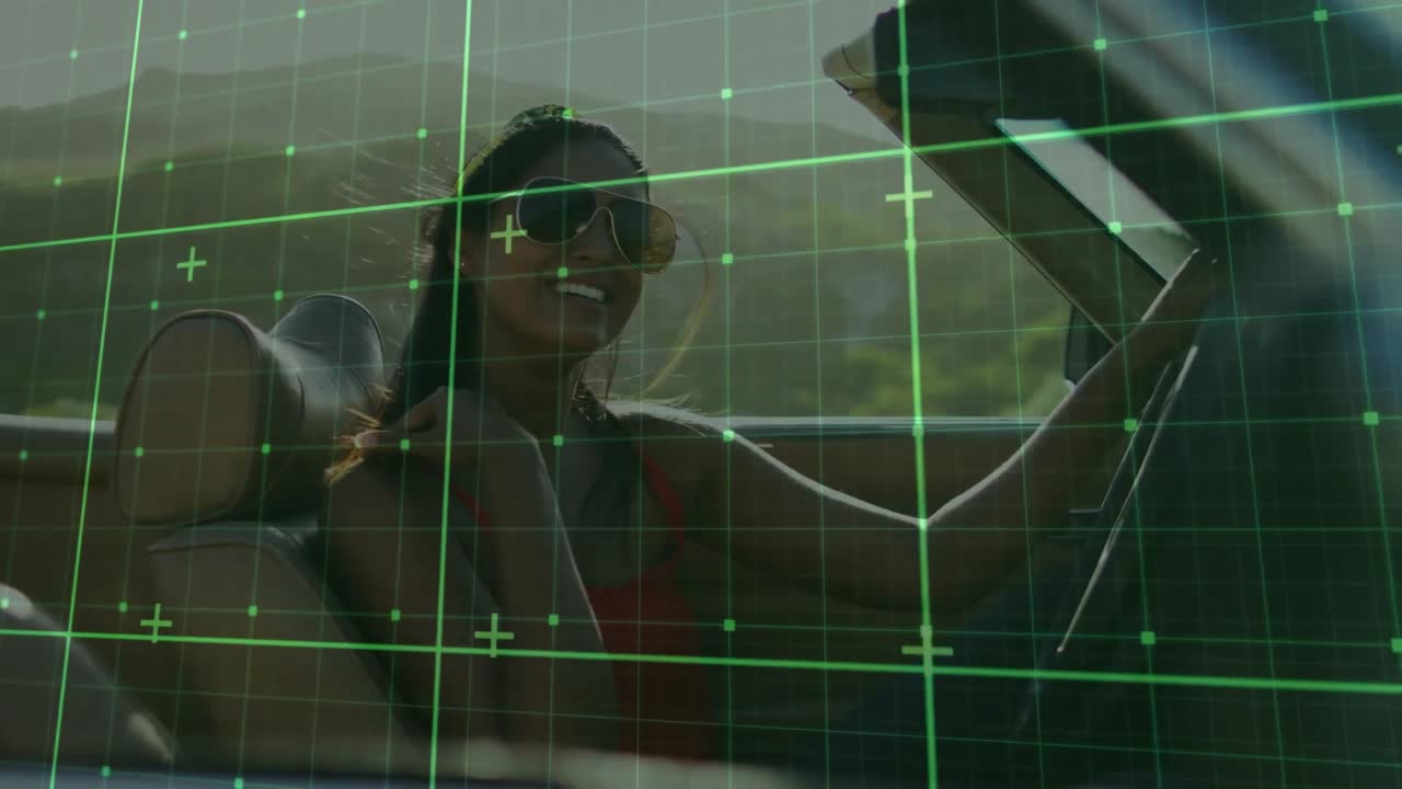 Female driver in convertible adjusting headband in breeze, animated grid overlay showing automotive