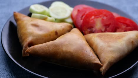 delicious samosas with tomato and cucumber salad