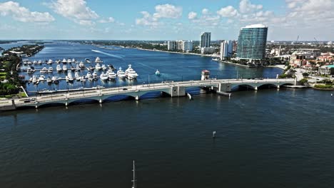 pull out drone shot of royal park bridge, one flagler and phillips point building during the day in west palm beach, florida, usa