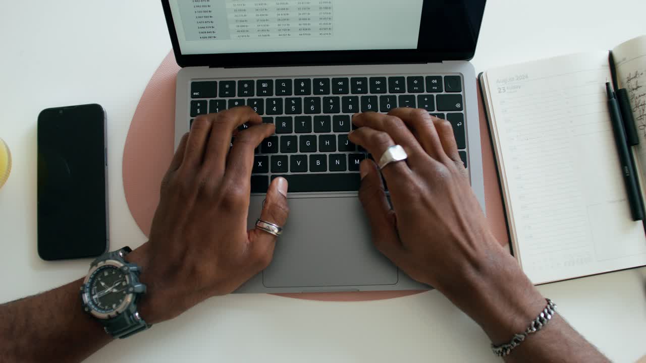 Person working on laptop with spreadsheet