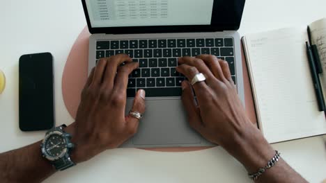 person working on laptop with spreadsheet