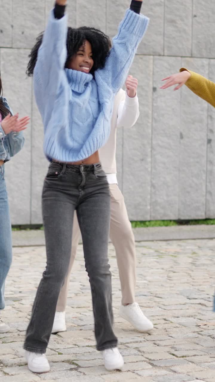 Multi-ethnic happy friends dancing excited in the city
