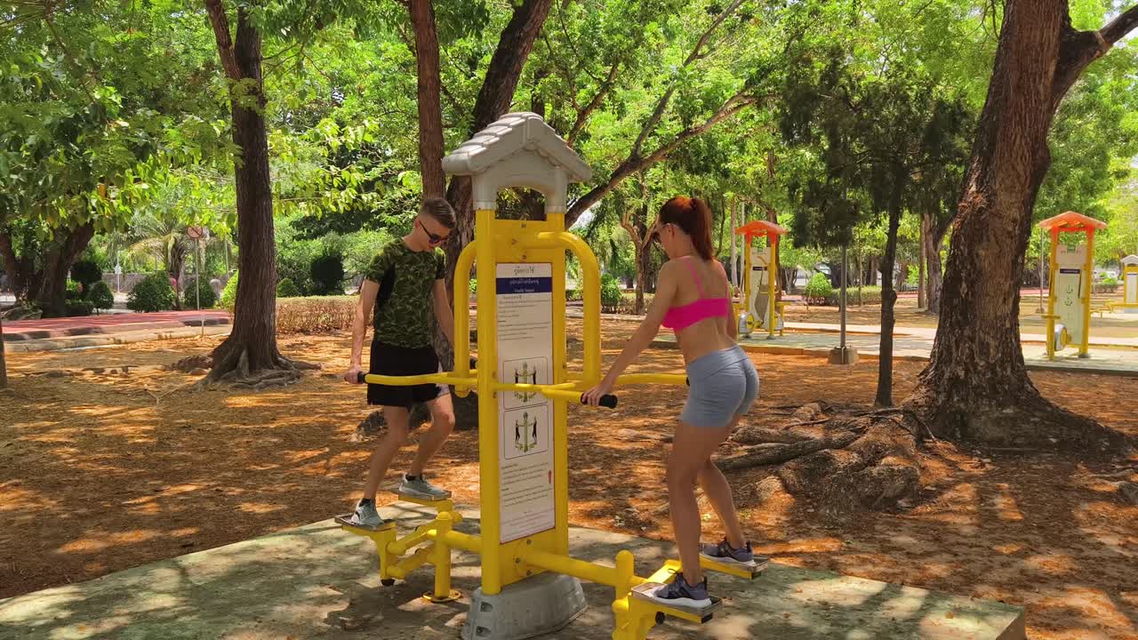 Couple working out outdoors at a park