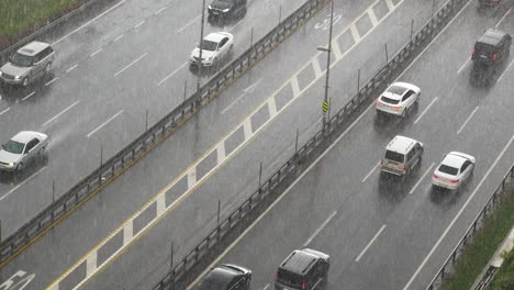 heavy rain on highway: cars driving through storm