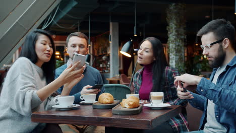 friends taking photos in cafe