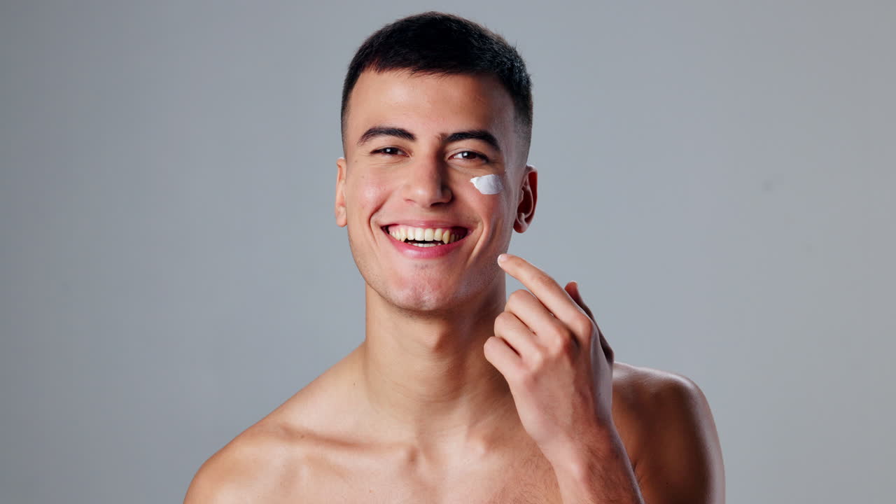 Man applying skincare cream to his face