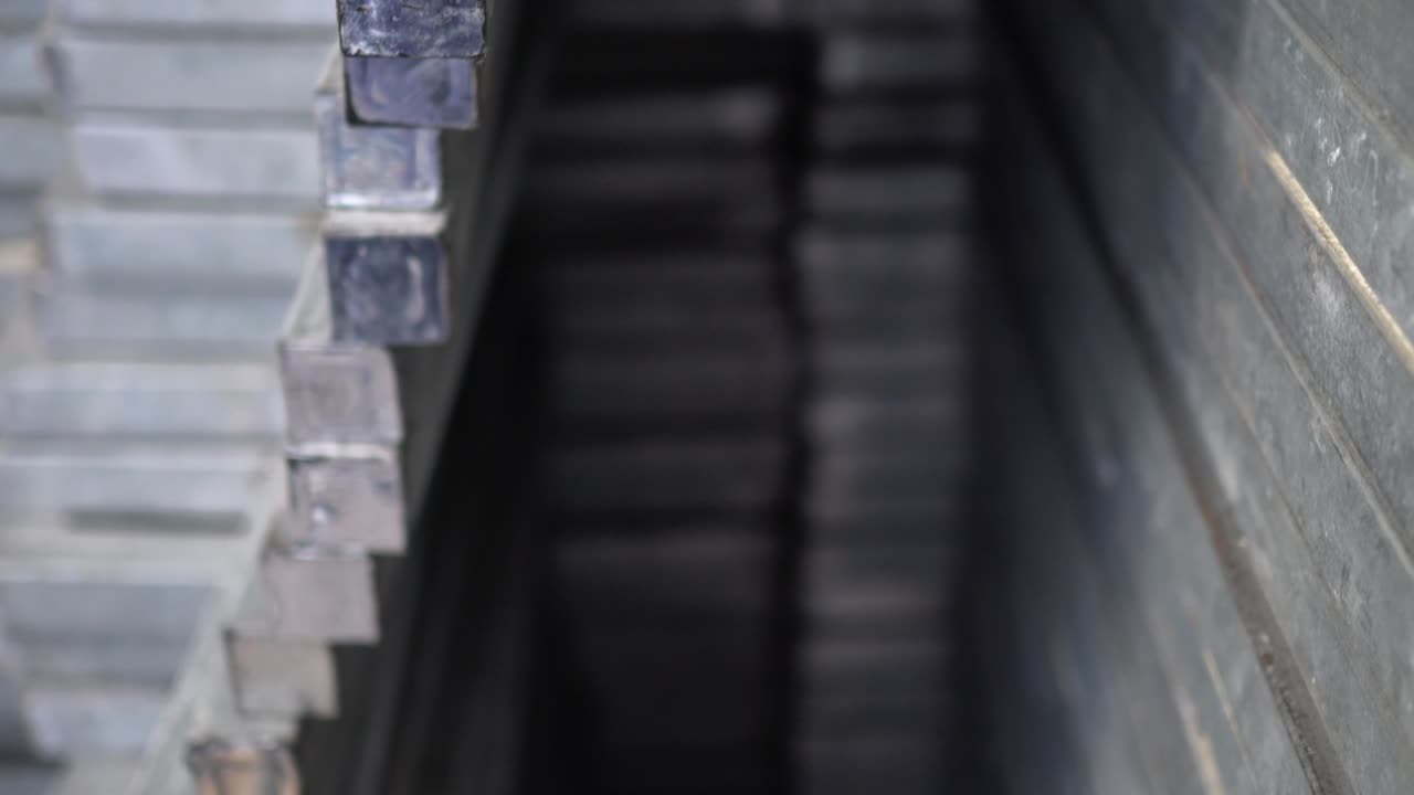 Metal recyclables are neatly arranged. Appearance is old. Tilt shot from bottom to top.