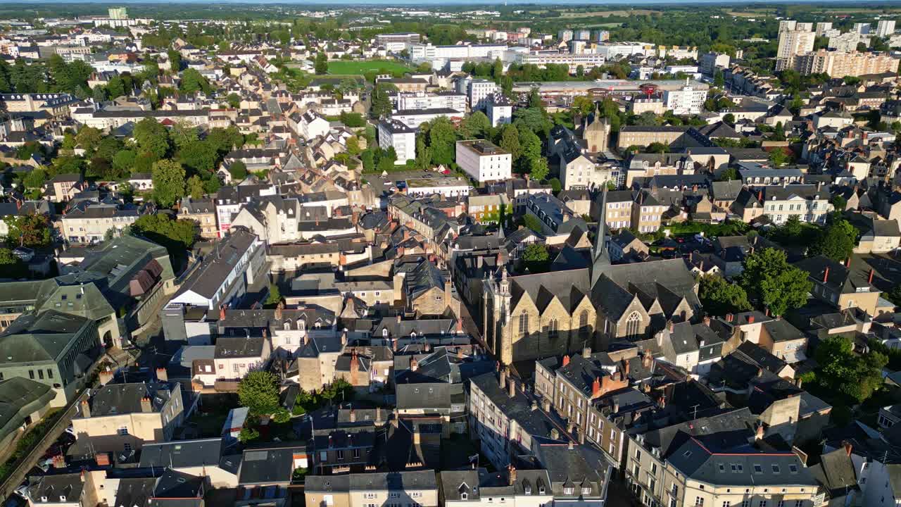 Église Saint-Vénérand, church and surrounding cityscape, Laval, France. Aerial drone sideways