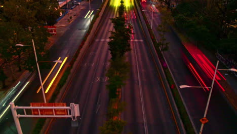 Nighttime-hyperlapse-featuring-the-vehicle-traffic-on-a-bustling-avenue,-with-yellow-and-reddish-tones,-evoking-the-vibe-of-Mexican-cities