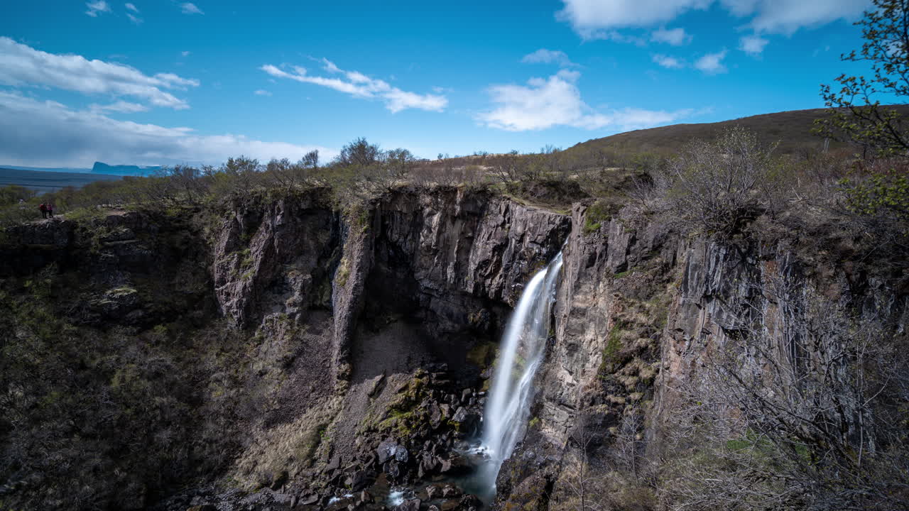 Timelapse of Clouds Moving Above Svartifoss Waterfall in Scenic Landscape of Highlands of Iceland