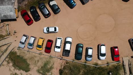 aerial overhead shot of a truck leaving a dirt parking