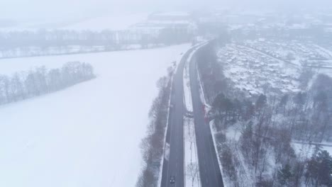 aerial view of cold snowy winter landscape, dense fog above highway near bochum, germany