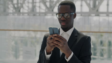 business man texting on smartphone in modern building