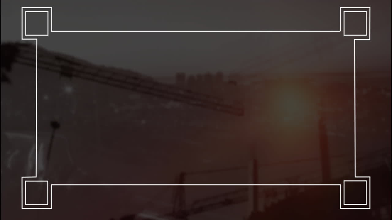 Cranes silhouetted against sunset, creating animation over city skyline construction