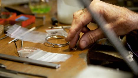 goldsmith working at desk in workshop 4k