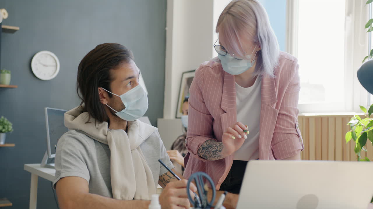 Two colleagues discussing design ideas in a modern office