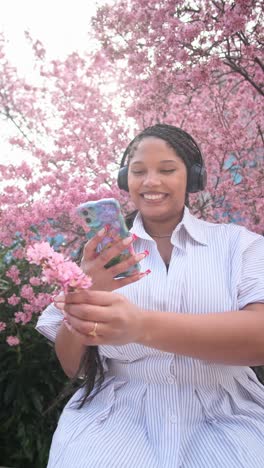 Young African American Woman Enjoying Phone call in Beautiful Outdoor Setting a Cheerful Young African American Woman Talks on her Phone while Spending Time Outdoors Surrounded by a Scenic and Pleasant Atmosphere