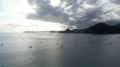 Sea-and-mountain-views-with-boats-in-the-foreground-in-Lombok,-Indonesia