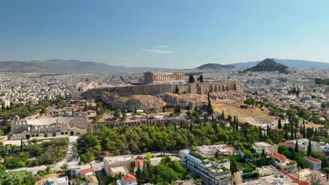 aerial uhd footage of acropolis, shot in full daylight, showing ancient columns, theater, and classical architecture with sprawling athens in the background.