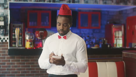 waiter smiling in a retro restraurant