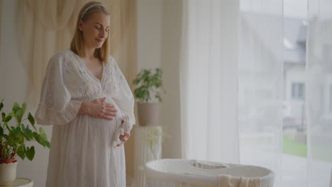 pregnant woman touching belly ninth month