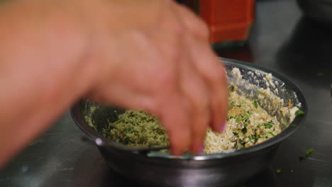 caucasian food - preparation of nigvziani badrijani spiced walnut-garlic paste