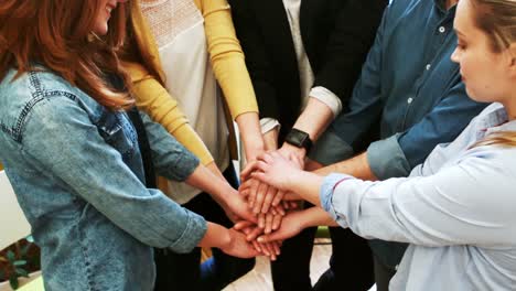 business executives forming hand stacked