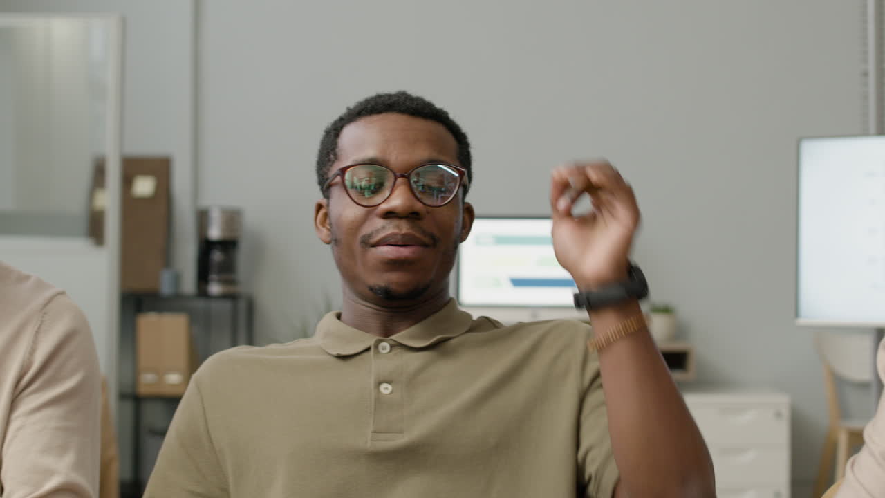 Man And Woman And Man Working Together Sitting At Desk In The Office Using Laptop Writting Notes