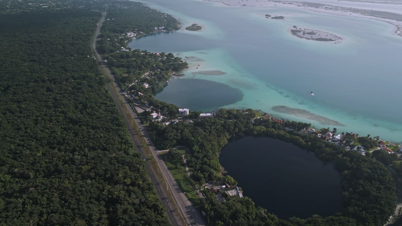 Drone aerial view of Bacalar cenotes with turquoise lagoon and tropical landscape