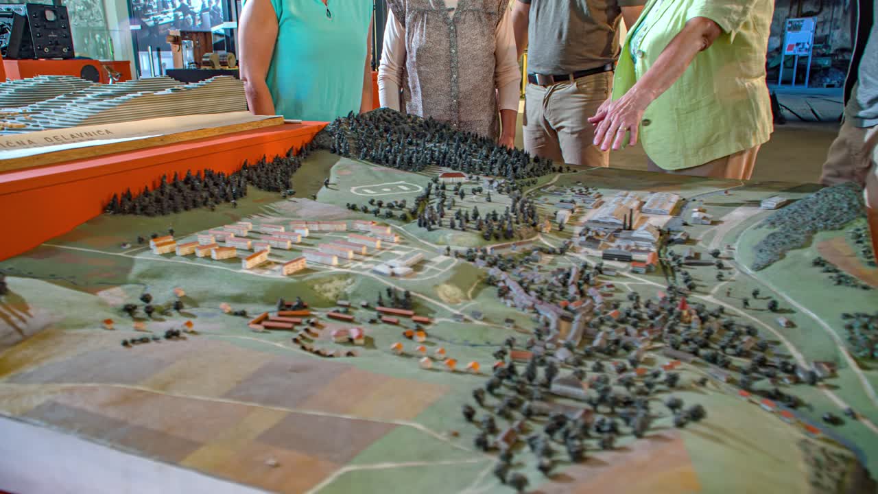 Miniature replica model of buildings, landscape and terrain inside museum