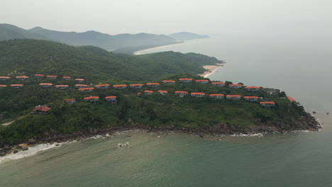 premium holiday villas on chan may bay peninsula look out over deep blue green ocean 4k