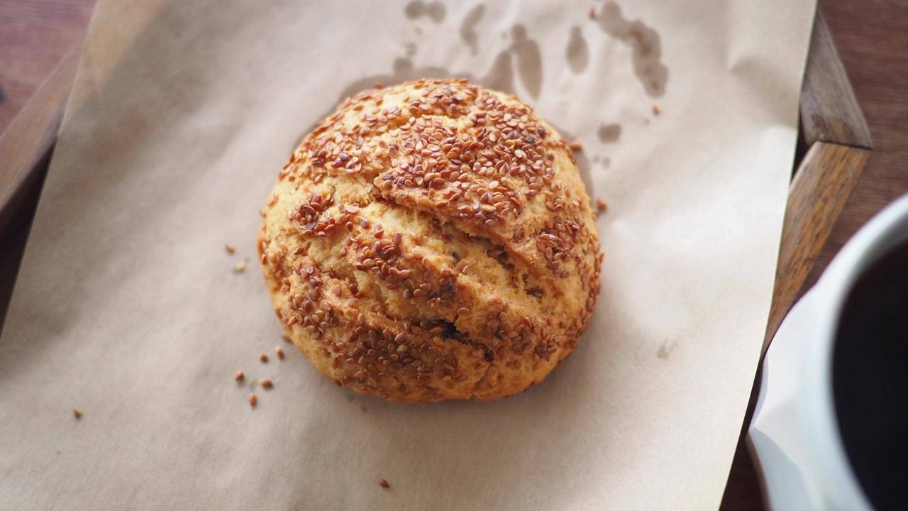 Overhead View of a Freshly Baked Sesame Seed Pastry and Coffee