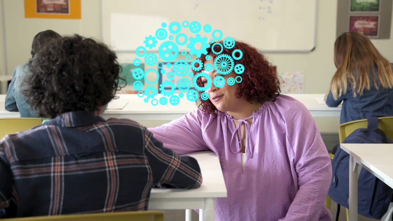 Teacher walking to student in class, leaning and guiding work while turquoise head expanding above