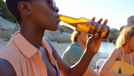 group of friends having beer in the beach 4k