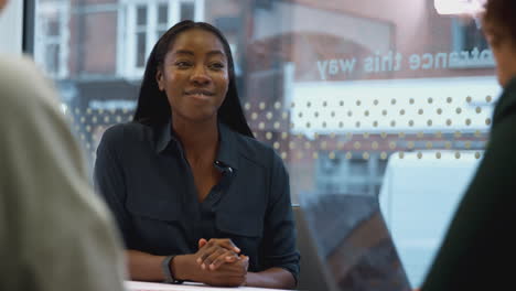 young african american businesswoman sitting at table in office meeting room