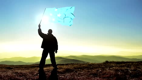 successful silhouette man winner waving micronesia flag on top of the mountain peak, cinemagraph loop background