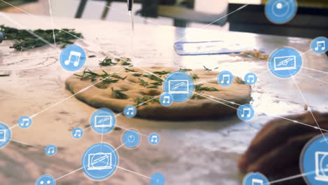 Animation-of-network-of-connections-with-icons-over-fresh-pizza-in-kitchen