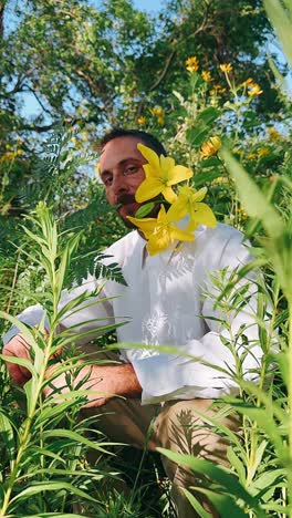 man in a field with yellow flowers