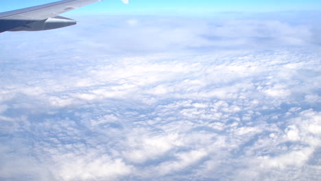 A-push-in-shot-of-an-airplane-window-while-cruising-at-30,000-feet