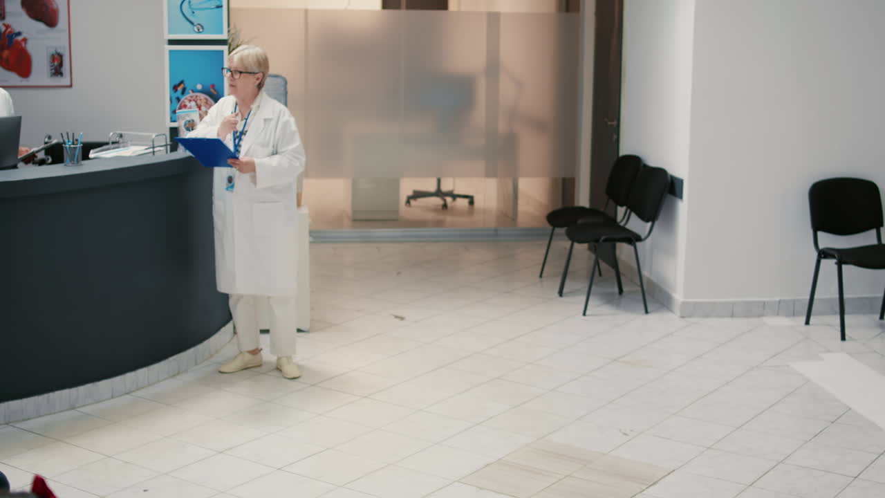 Hospital waiting room with medical staff assisting patient in wheelchair