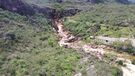 Aerial-drone-of-old-villa-structure-with-mountains-in-background