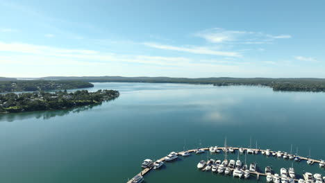 aerial drone shot flying over a small marina at trinity point near morisset park, lake macquarie, nsw australia