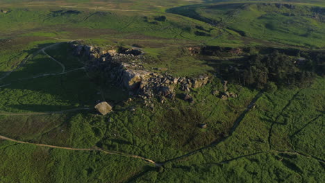 Establishing-Drone-Shot-of-Cow-and-Calf-Rocks-on-Ilkley-Moore-at-Golden-Hour-Sunset-West-Yorkshire-UK