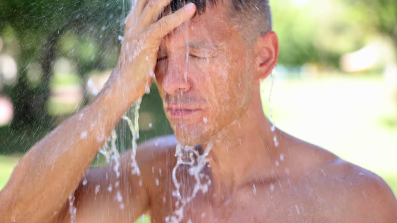 Man taking a shower outdoors