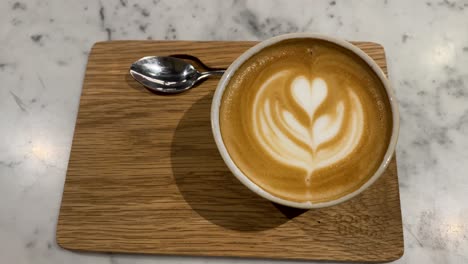 Close-Up-Footage-Of-A-Cup-Of-Coffee-With-Latte-Art-On-Top