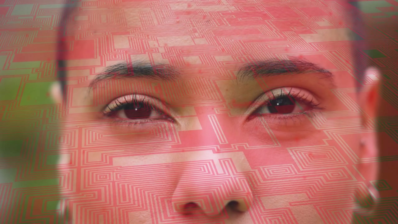 Woman in her 20s responding to red overlay shifting across face, blinking and winking in garden