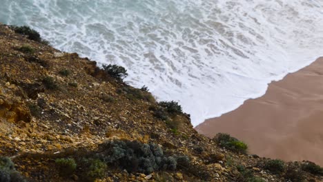 ocean waves hitting a rocky beach