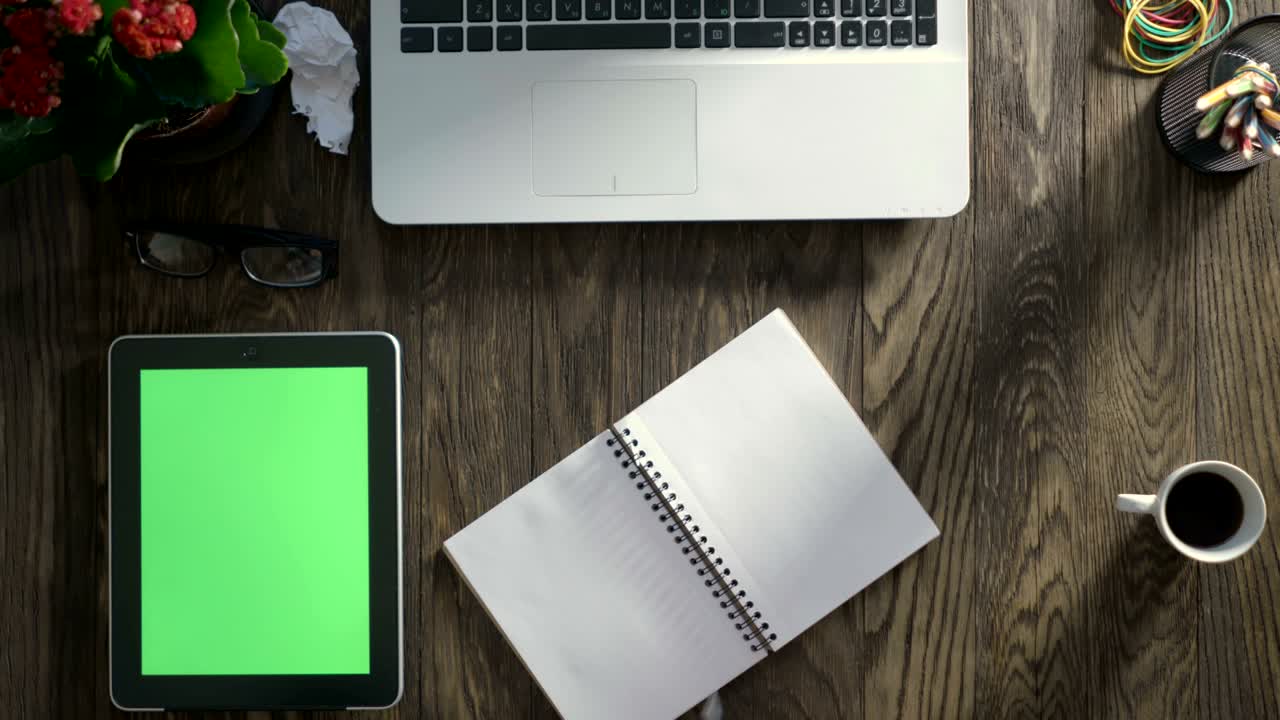Top view of wooden table with office supplies.