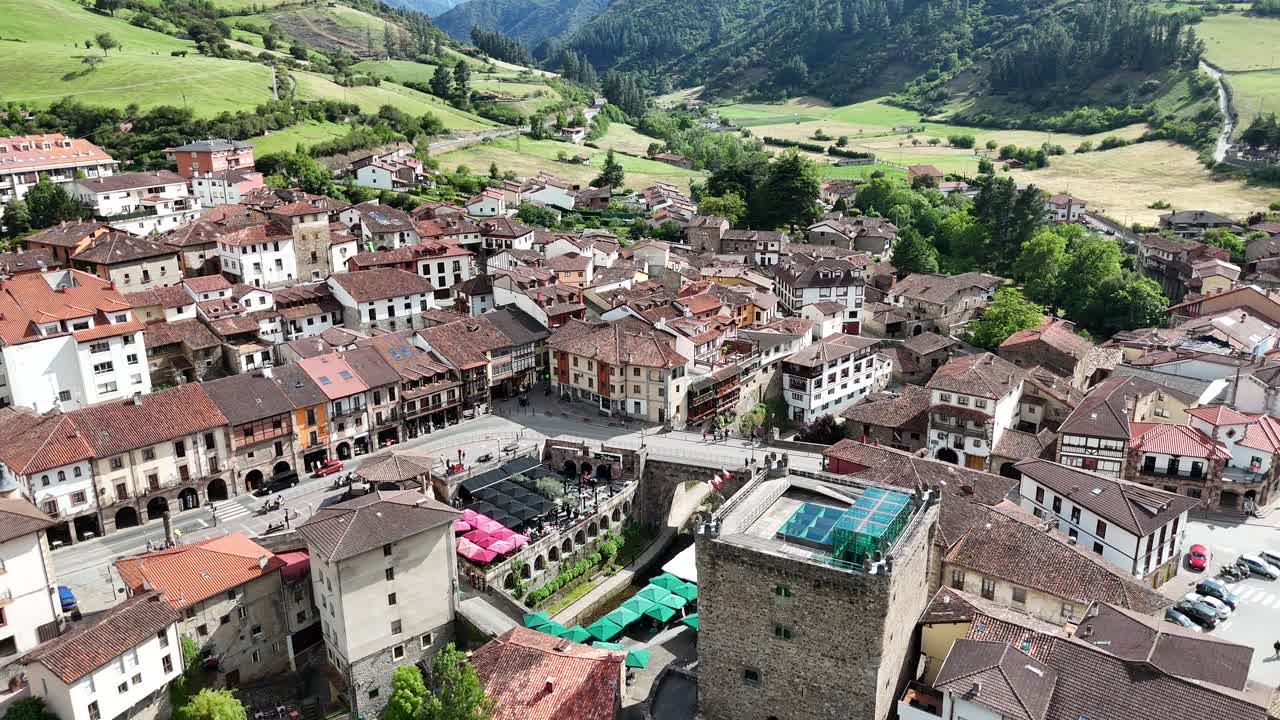 Aerial view of a charming European town nestled in a green valley